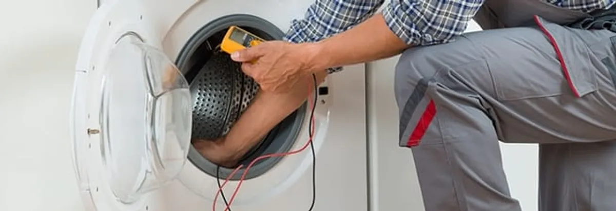 Dryer repair technician inspecting and repairing a clothes dryer in Oklahoma City, OK