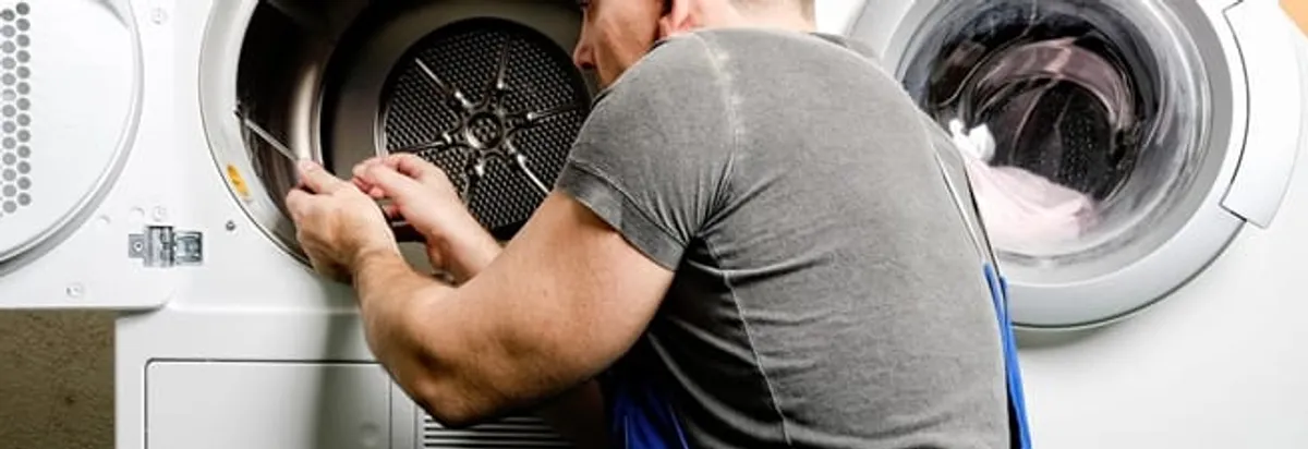 Dryer repair technician fixing a clothes dryer drum in Oklahoma City, OK